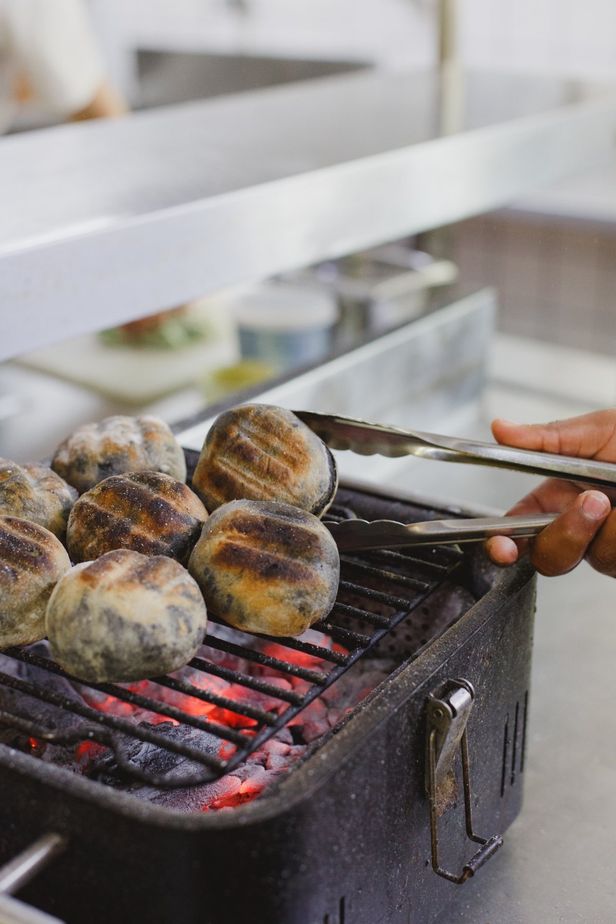 Round breads toasting over glowing coals at Melfort