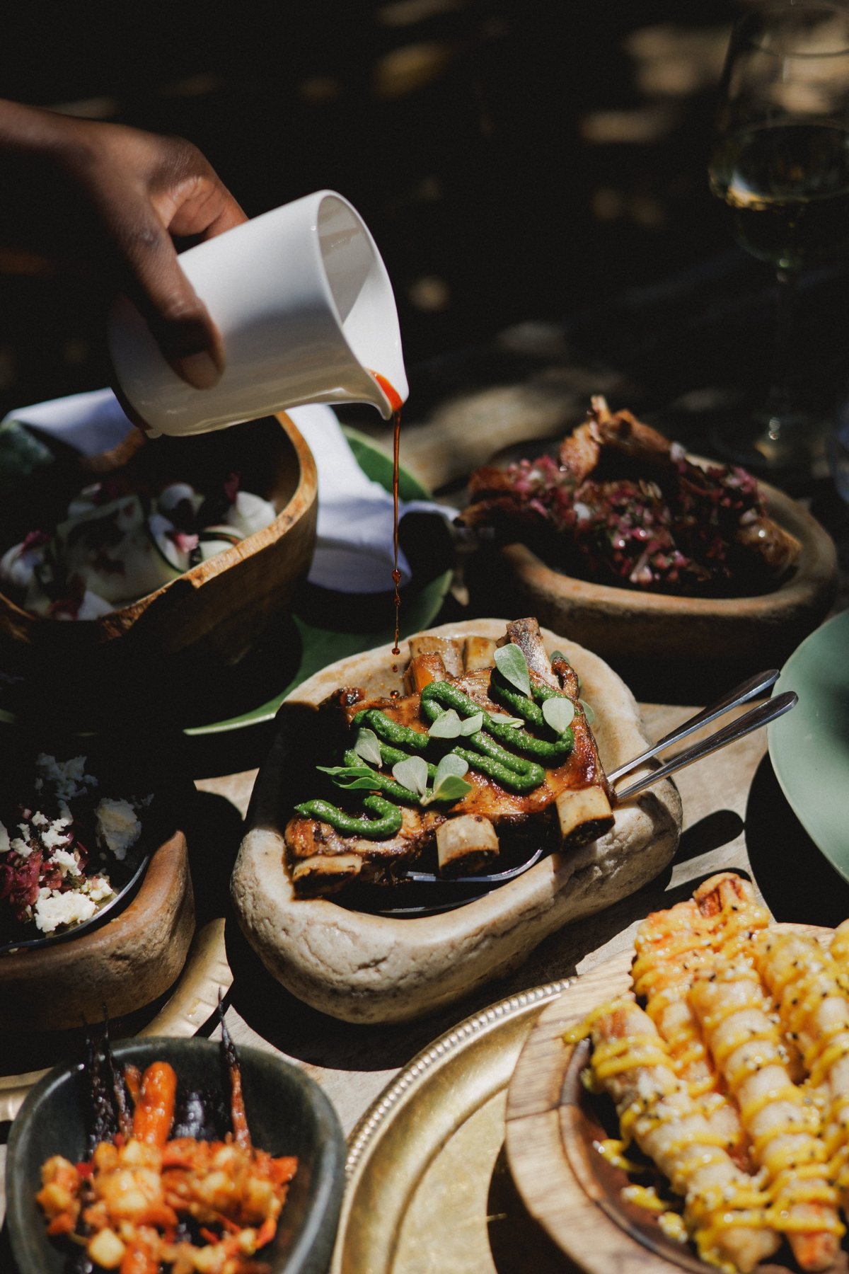Sharing dishes with vegetables and corn on a sunlit table at Melfort